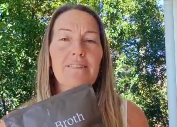 Melissa holding HEWN Bone Broth Protein