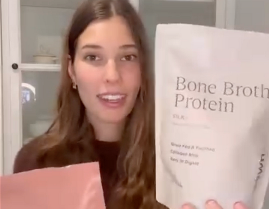 Kerrie-lee holding HEWN Bone Broth Protein